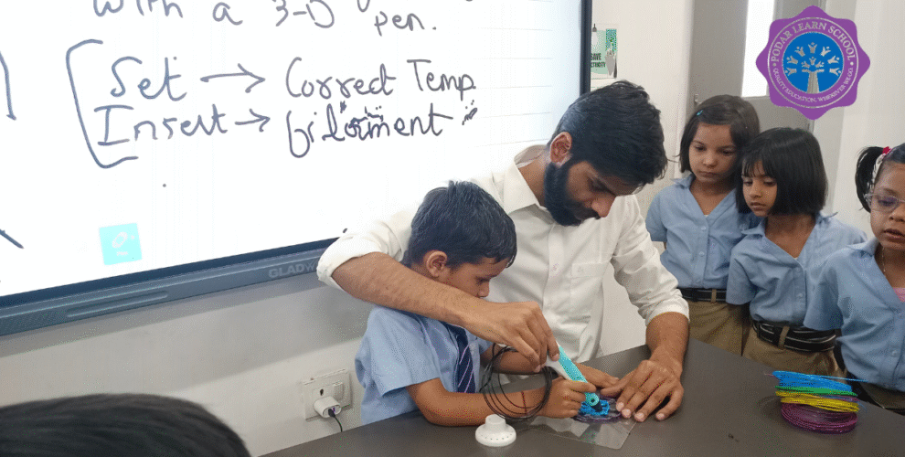 A teacher guiding a young student using a 3D pen in the AI Lab at Greater Noida Podar Learn School, with other children observing and learning hands-on creativity.