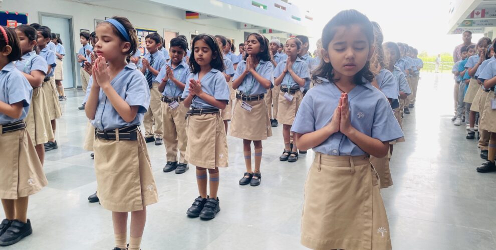 Students reciting shlokas with folded hands on Sanskrit Diwas at Greater Noida Podar Learn School