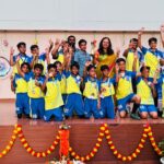 Principal of Greater Noida Podar Learn School with coaches and winning football team at Major Dhyan Chand Khel Mahotsav 2025