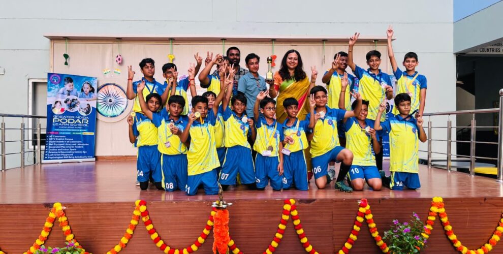 Principal of Greater Noida Podar Learn School with coaches and winning football team at Major Dhyan Chand Khel Mahotsav 2025
